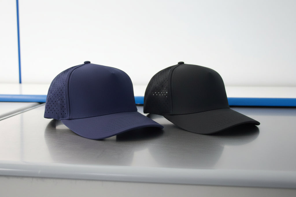 Navy blue cap with perforated design on a reflective surface